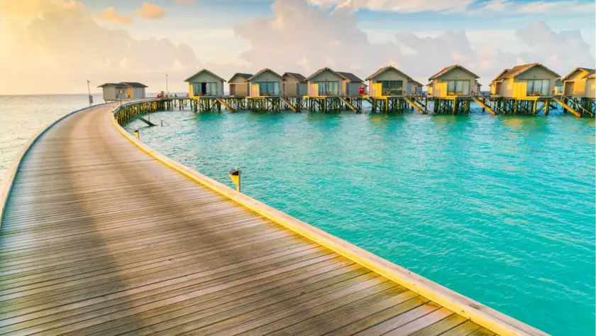 Overwater villas in Maldives surrounded by turquoise sea