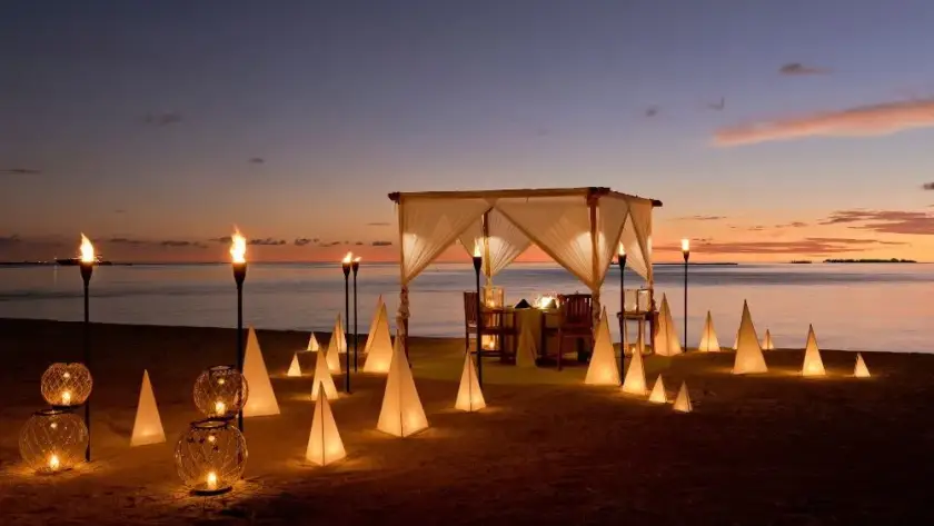 Romantic private candlelit beach dinner in the Maldives with ocean views at sunset