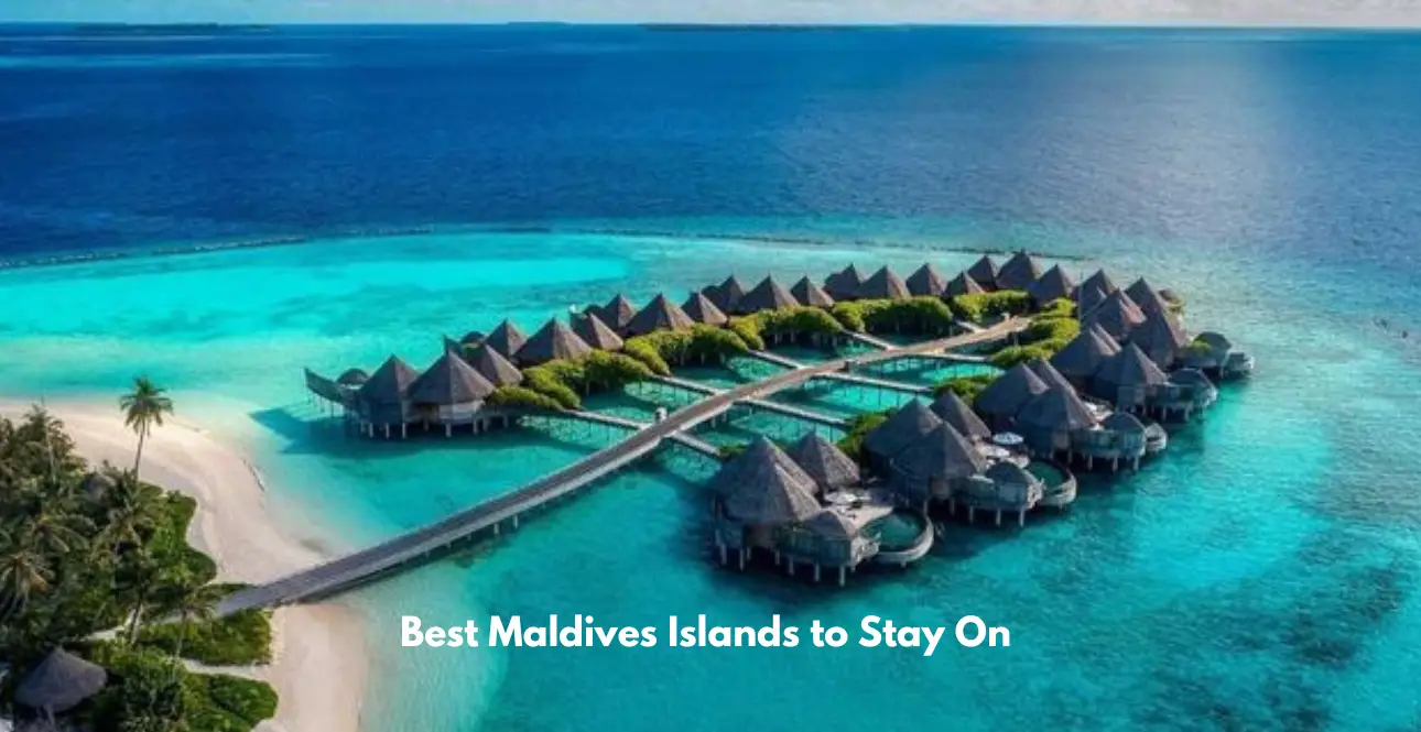 Aerial view of luxury overwater villas surrounded by turquoise lagoon waters on a Maldives island