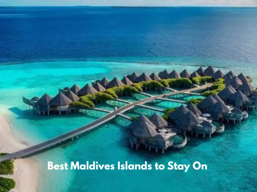 Aerial view of luxury overwater villas surrounded by turquoise lagoon waters on a Maldives island