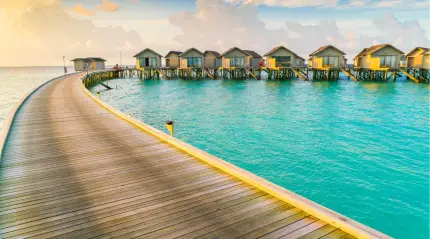 Overwater villas in Maldives surrounded by turquoise sea