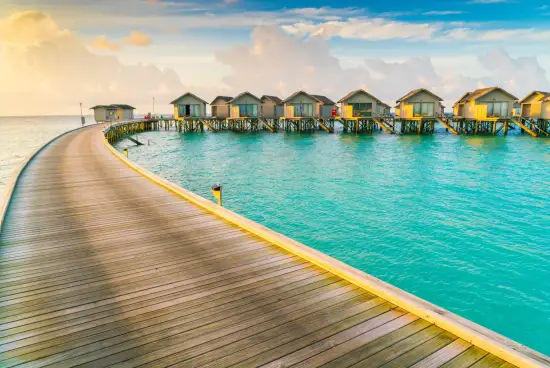 Overwater villas in Maldives surrounded by turquoise sea